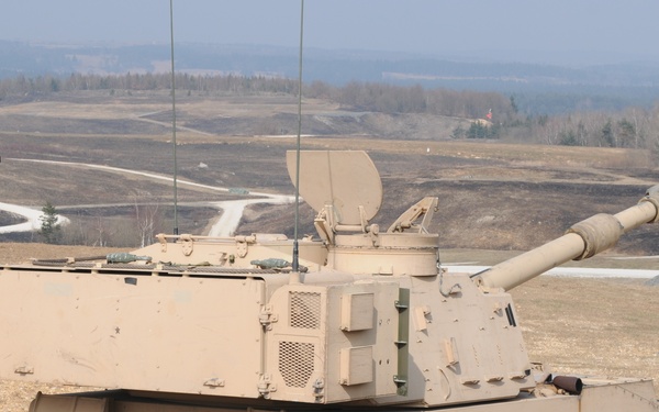 Several M109A6 Paladin self-propelled howitzers conduct test fire