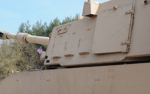 Several M109A6 Paladin self-propelled howitzers conduct test fire