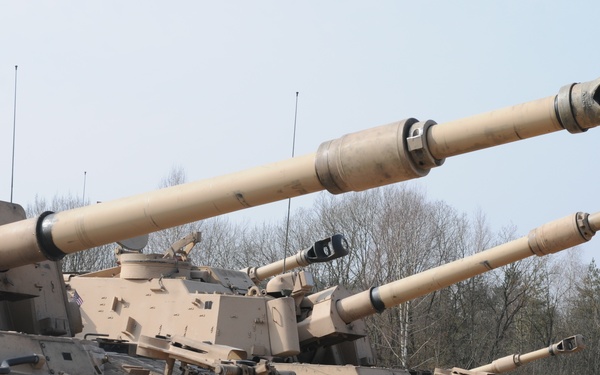 Several M109A6 Paladin self-propelled howitzers conduct test fire