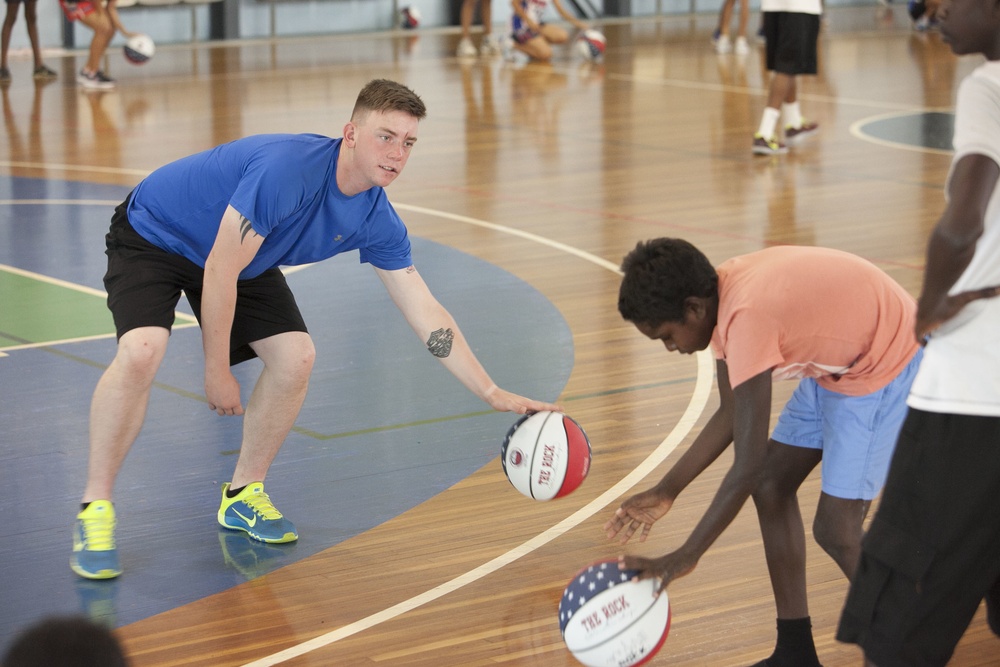 US Marines mentor local children at basketball clinic