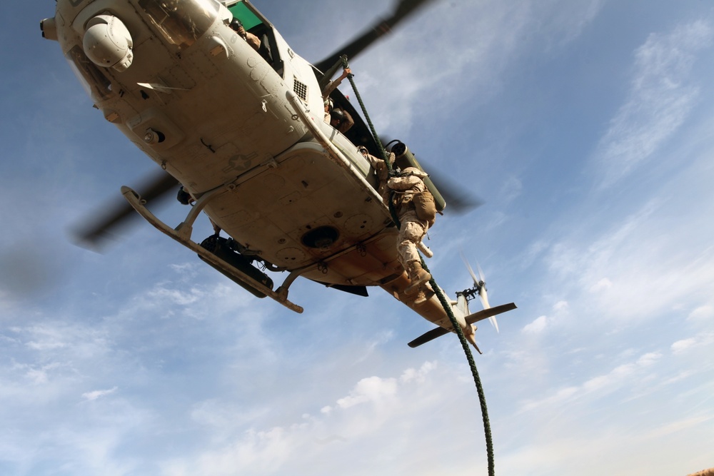 Marines fast rope from hueys during WTI