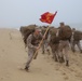 Marine runs around formation with guidon during hike