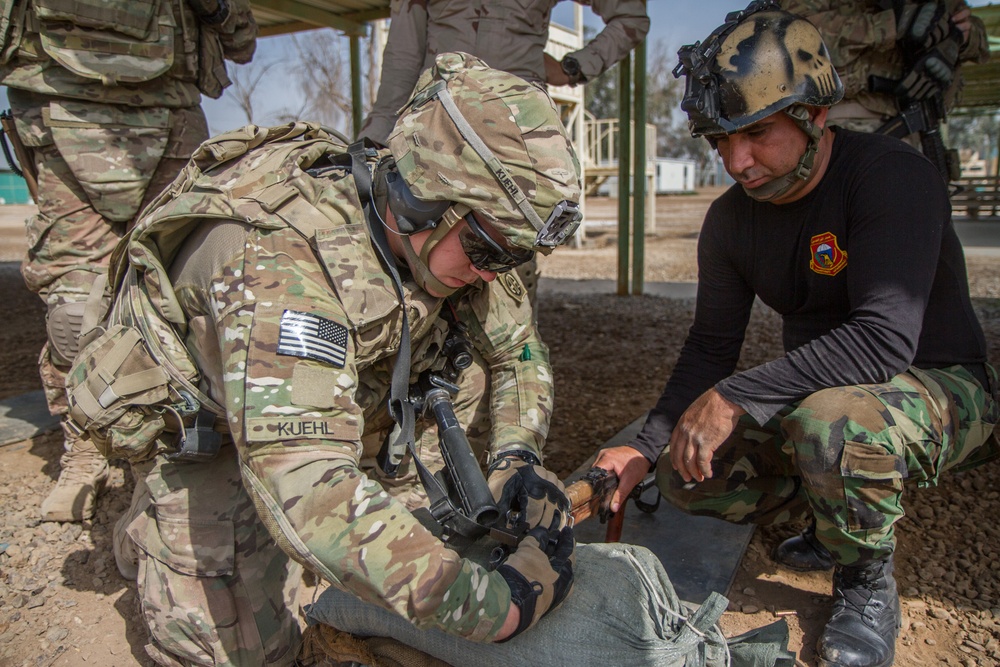 Paratrooper helps adjust Iraqi rifle