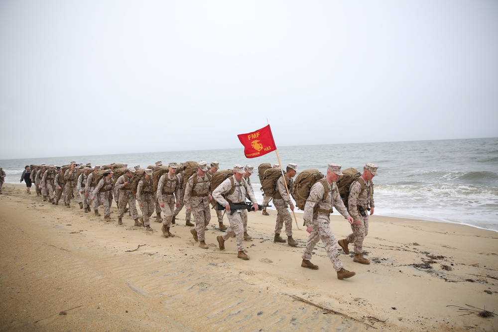 Marines conduct beach hike enhancing unit morale, maintain combat readiness.