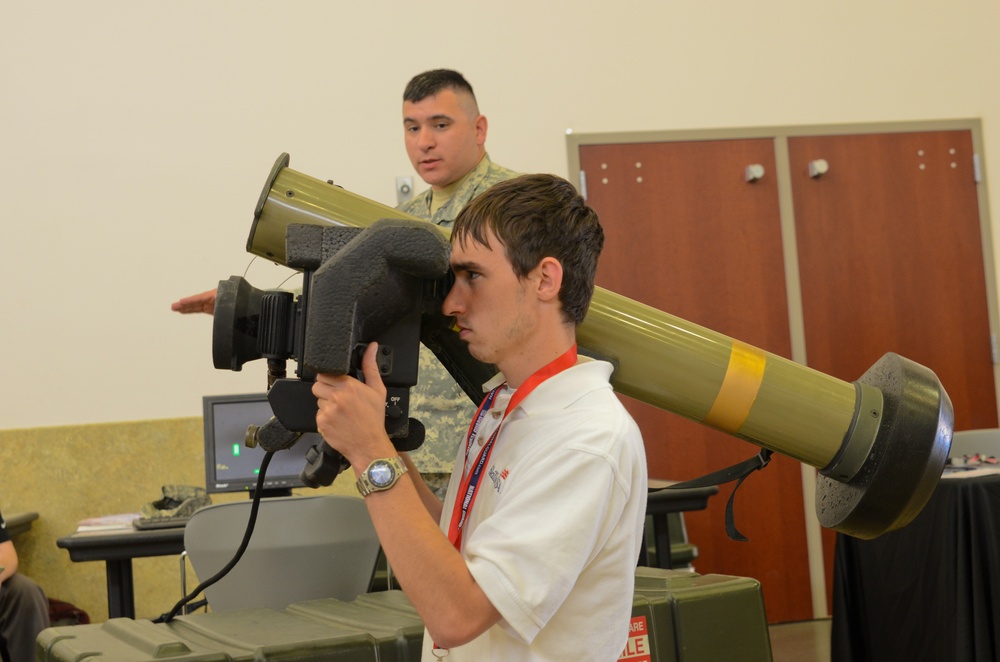 A contestant tries his hand at a rocket launcher simulator