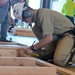 Participant in carpentry competition measures twice and cuts once