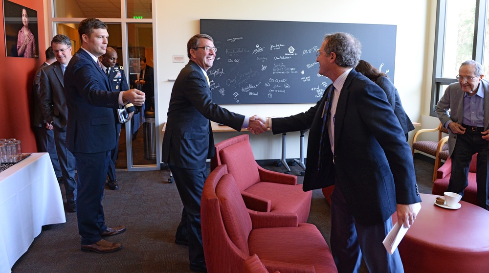 Secretary of Defense Ash Carter shakes hands with Dr. David Relmann the Stanford University Cemex Auditorium
