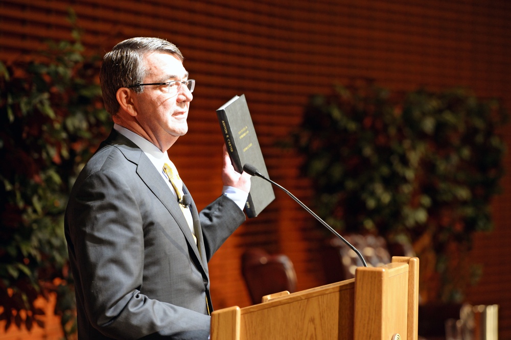 Secretary of Defense Ash Carter holds up his dissertation while speaking at the Drell Lecture at Stanford University