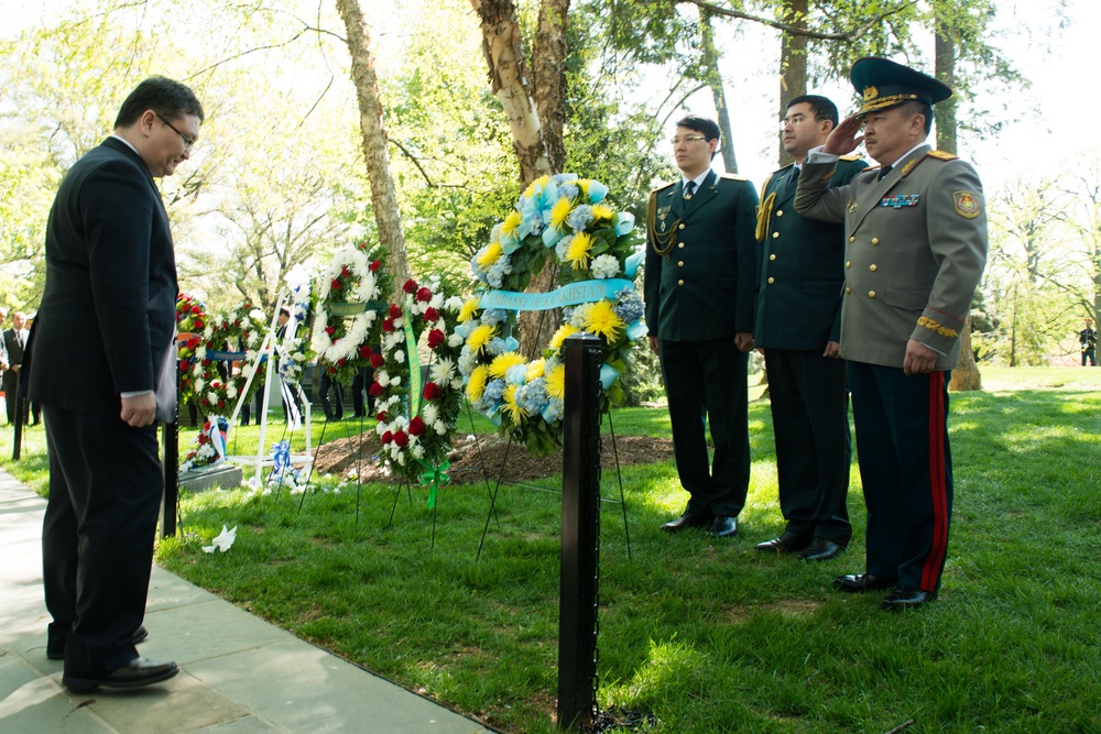 Representatives from the Embassy of Kazakhstan lay a wreath at the Spirit of the Elbe marker in Arlington National Cemetery