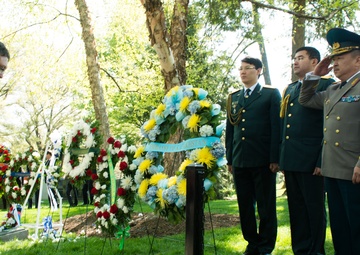Representatives from the Embassy of Kazakhstan lay a wreath at the Spirit of the Elbe marker in Arlington National Cemetery