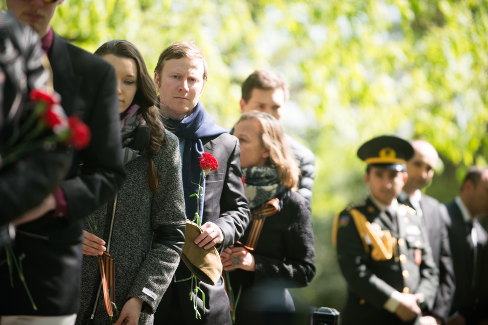 Attendees wait to lay flowers on The Spirit of the Elbe marker in Arlington National Cemetery