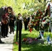 Attendees lay flowers on The Spirit of the Elbe marker in Arlington National Cemetery
