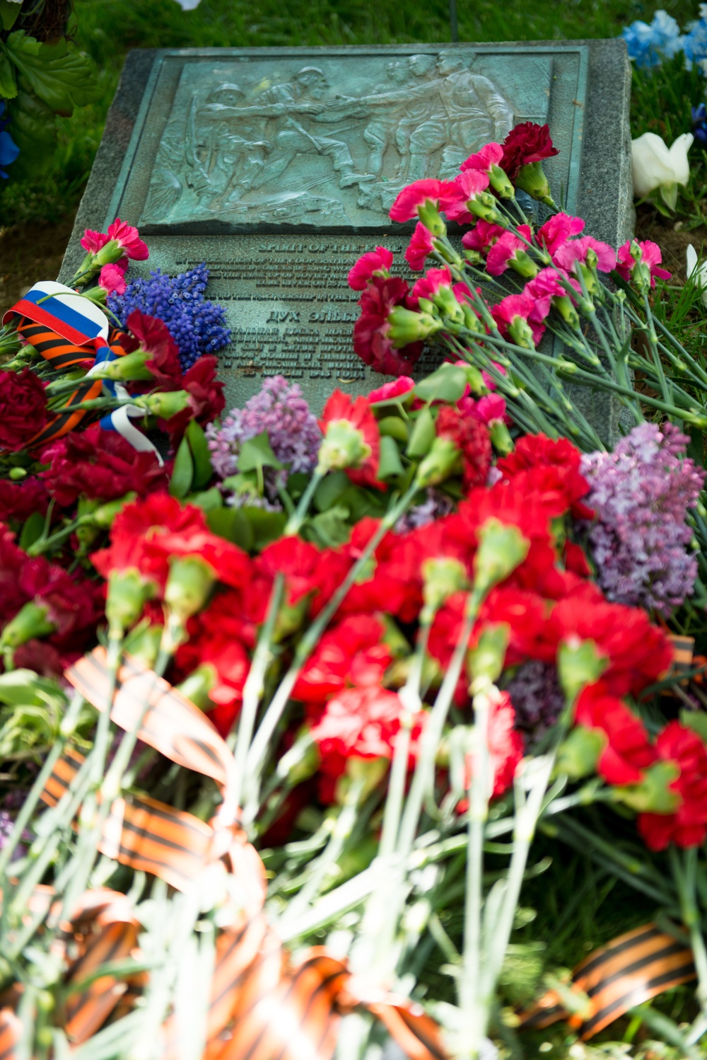 Flowers lay on the Spirit of the Elbe marker in Arlington National Cemetery