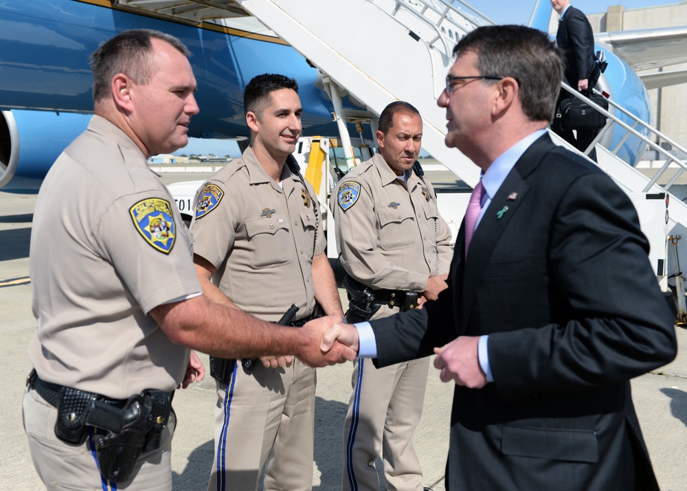 Secretary of Defense Ash Carter presents law enforcement officers with SECDEF coin