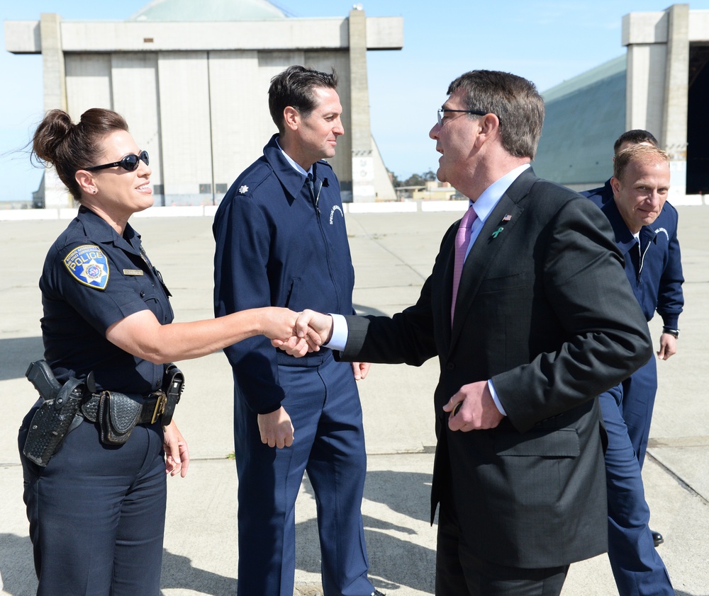 Secretary of Defense Ash Carter presents police officer with SECDEF coin