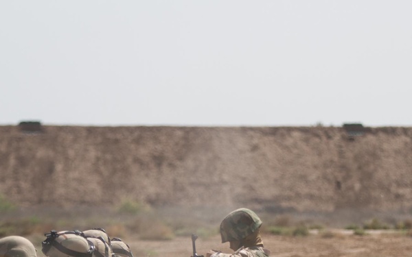 IA soldier reloads while 82nd advises