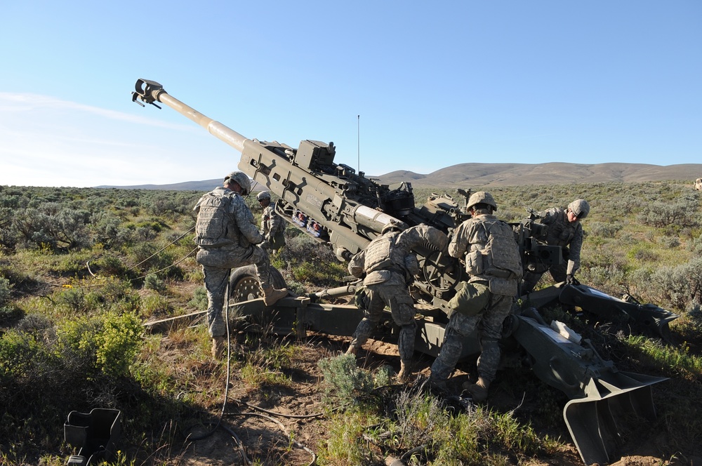 1-37 Field Artillery at YTC preparing to fire a M777 howitzer
