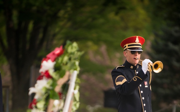 A bugler from The US Army Band 'Pershing’s Own' plays Taps during a wreath-laying ceremony at the Tomb of the Unknown Soldier, Arlington National Cemetery