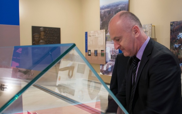 Republic of Croatia minister of veterans affairs places a gift into a display case in Memorial Display Room, Arlington National Cemetery