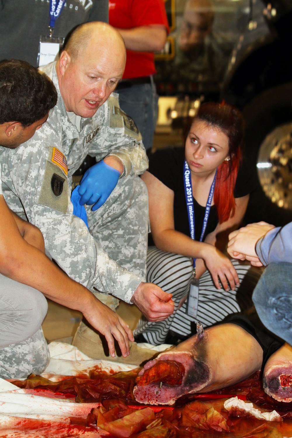 Army Reservist shows youth Multiple Amputation Trauma Trainer at career fair