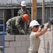 Soldiers of different trades pitch in to lay block