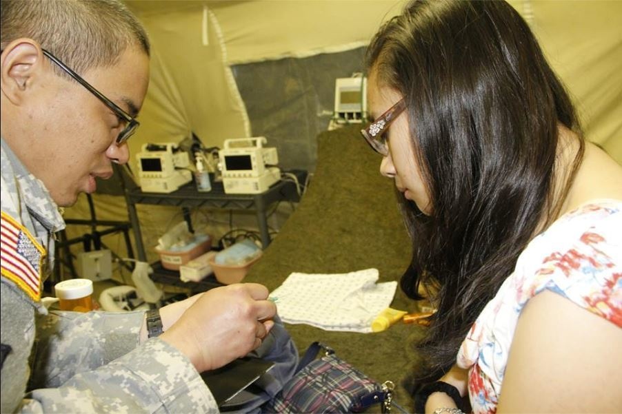 Showing his daughter an intravenous catheter