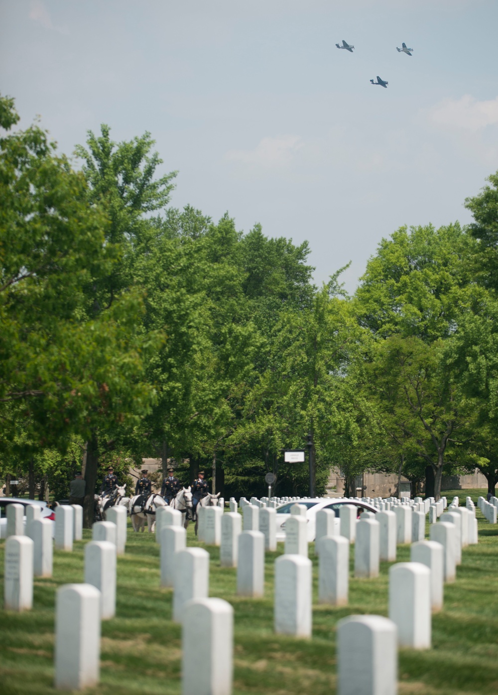 World War II era planes fly over Washington, D.C. seen from Arlington National Cemetery