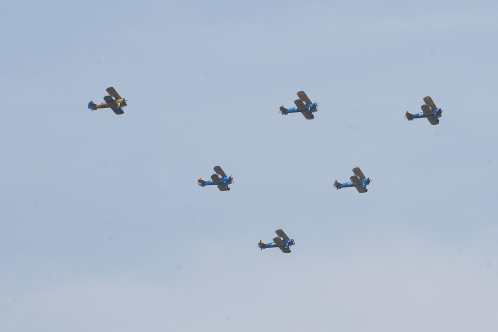 World War II era planes fly over Washington, DC, seen from Arlington National Cemetery