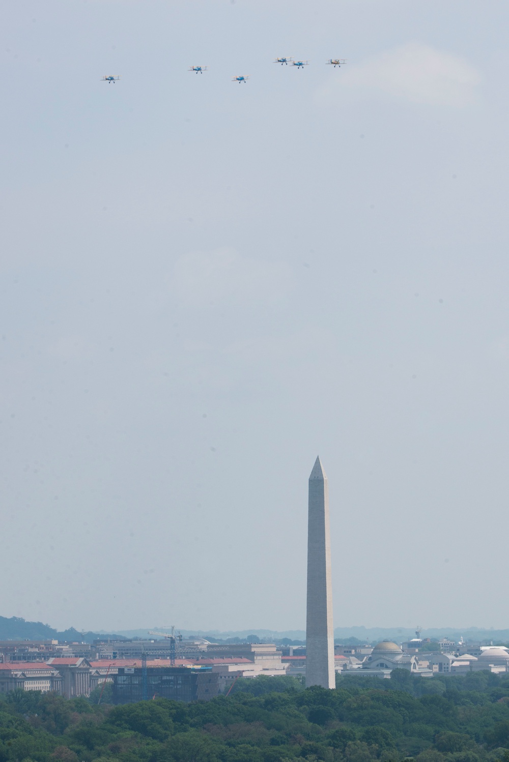 World War II era planes fly over Washington, DC seen from Arlington National Cemetery