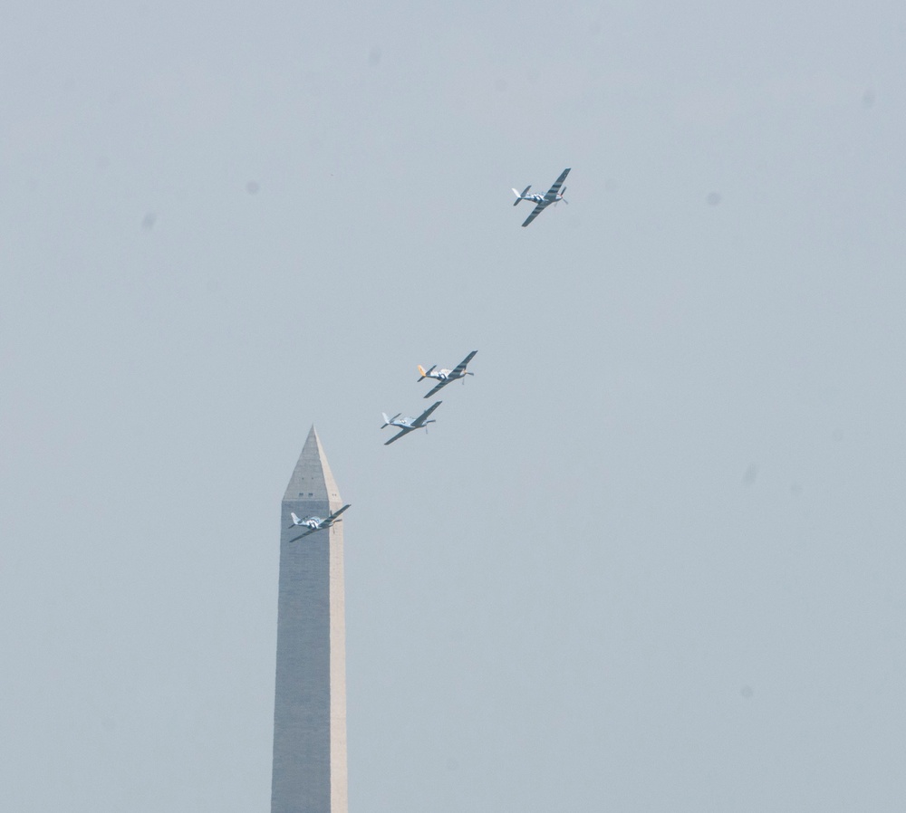 World War II era planes fly over Washington, DC seen from Arlington National Cemetery