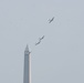 World War II era planes fly over Washington, DC seen from Arlington National Cemetery