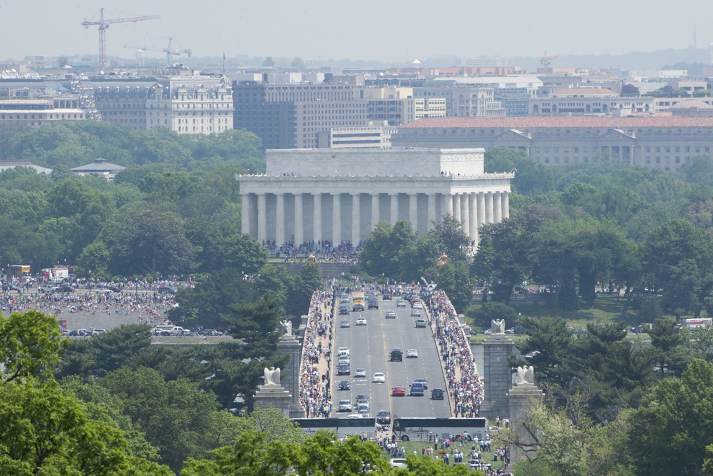 World War II era planes fly over Washington, D.C. seen from Arlington National Cemetery