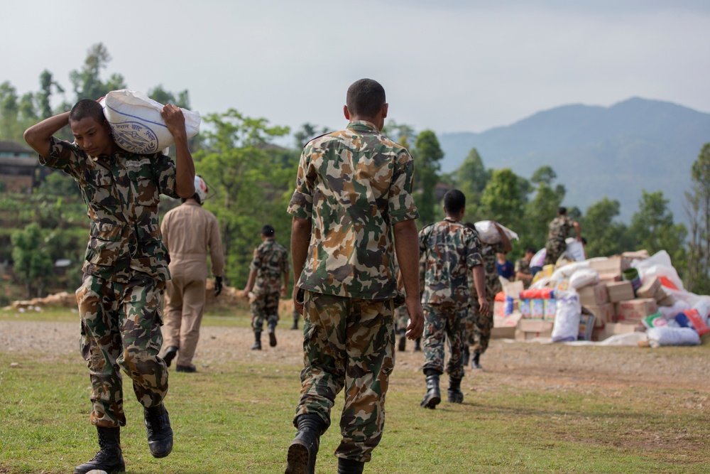 Nepalese and JTF 505 transport personnel and deliver supplies
