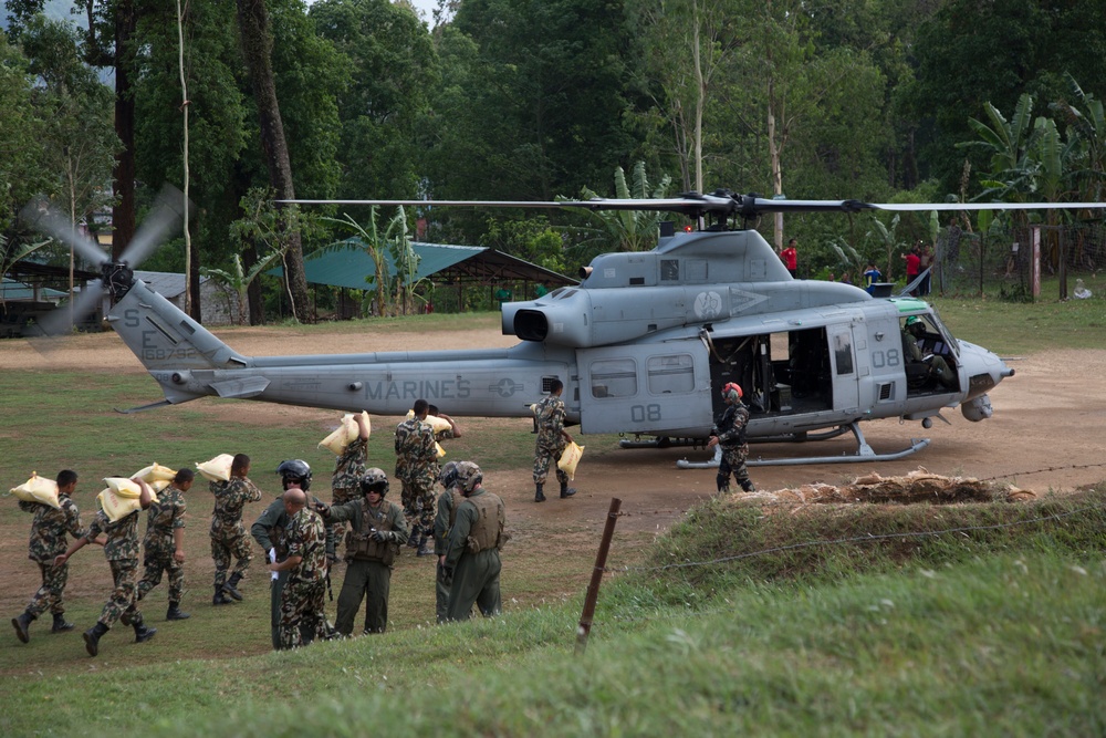Nepalese and JTF 505 transport personnel and deliver supplies