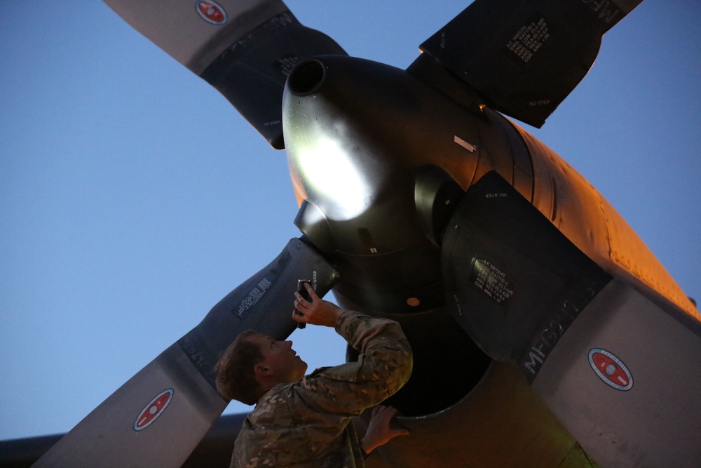 A US crew member conducts pre-flight checks on the AC-130W Gunship at the Prince Hashim Royal Air Base