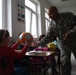Soldiers bring gifts and teach dental hygiene to students