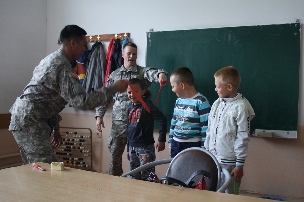Soldiers bring gifts and teach dental hygiene to students