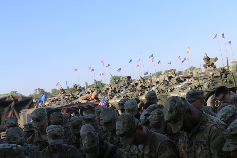 Soldiers pray before the long drive across Romania