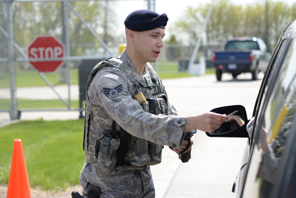 Airman working security at base entry