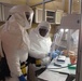 Technicians set up an assay test for Ebola