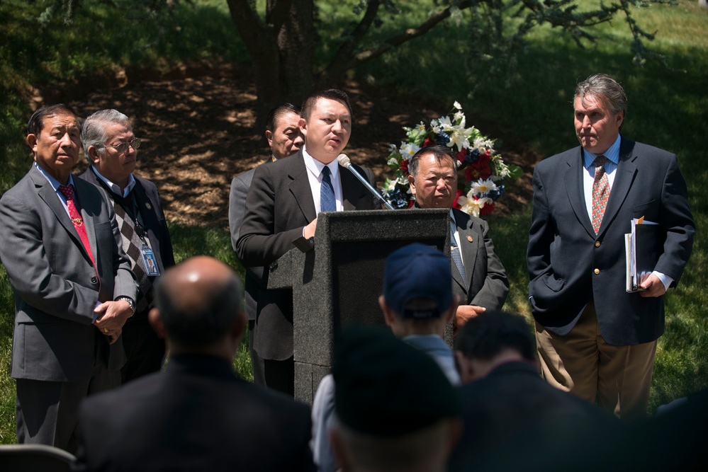 A ceremony honoring Hmong and Lao combat veterans at the memorial tree and plaque in Arlington National Cemetery