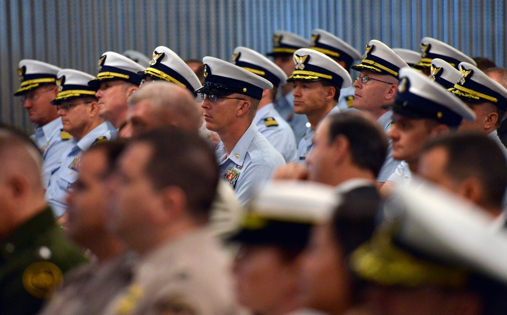 Crewmembers watch the Eighth District change of command