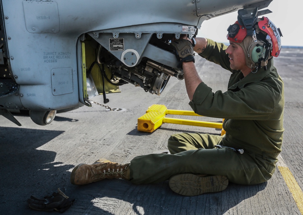 US Marines make sure helicopter's weapons are ready to fire at sea