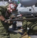 US Marines make sure helicopter's weapons are ready to fire at sea