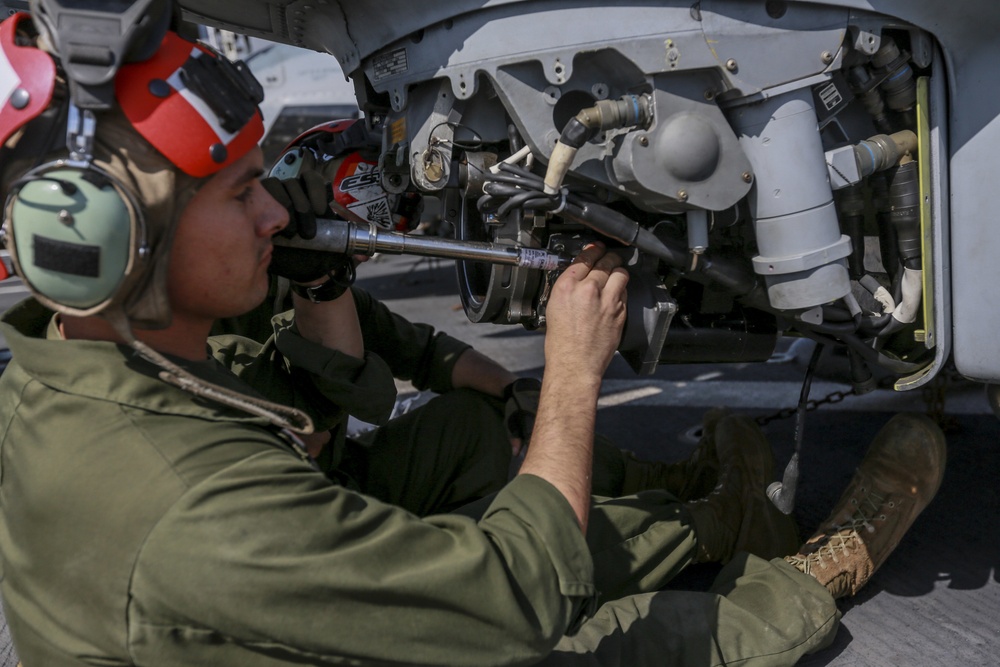 US Marines make sure helicopter's weapons are ready to fire at sea