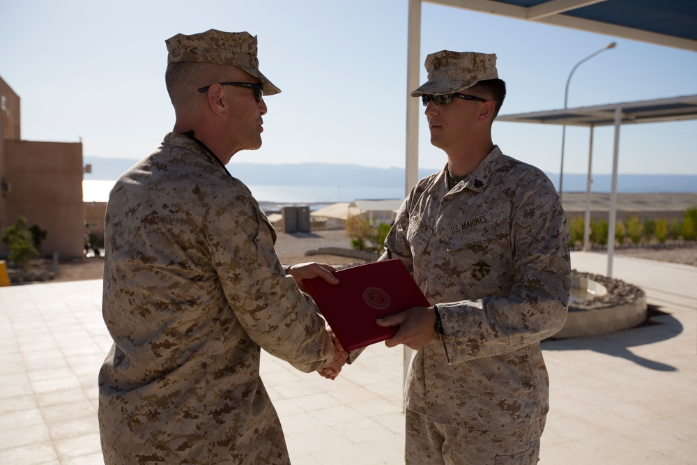 Marine receives diploma during multi-national exercise