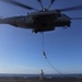US Marines fast rope from helicopters at sea