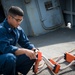 Sailor works on pilot's ladder