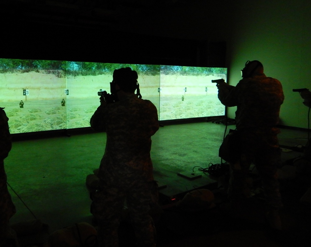 3rd Medical Command (Deployment Support), Detachment 11, (3d MCDS, Det.11) practice firing the M9 in the Engagement Skills Trainer (EST) while donning their protective masks