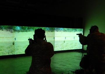 3rd Medical Command (Deployment Support), Detachment 11, (3d MCDS, Det.11) practice firing the M9 in the Engagement Skills Trainer (EST) while donning their protective masks